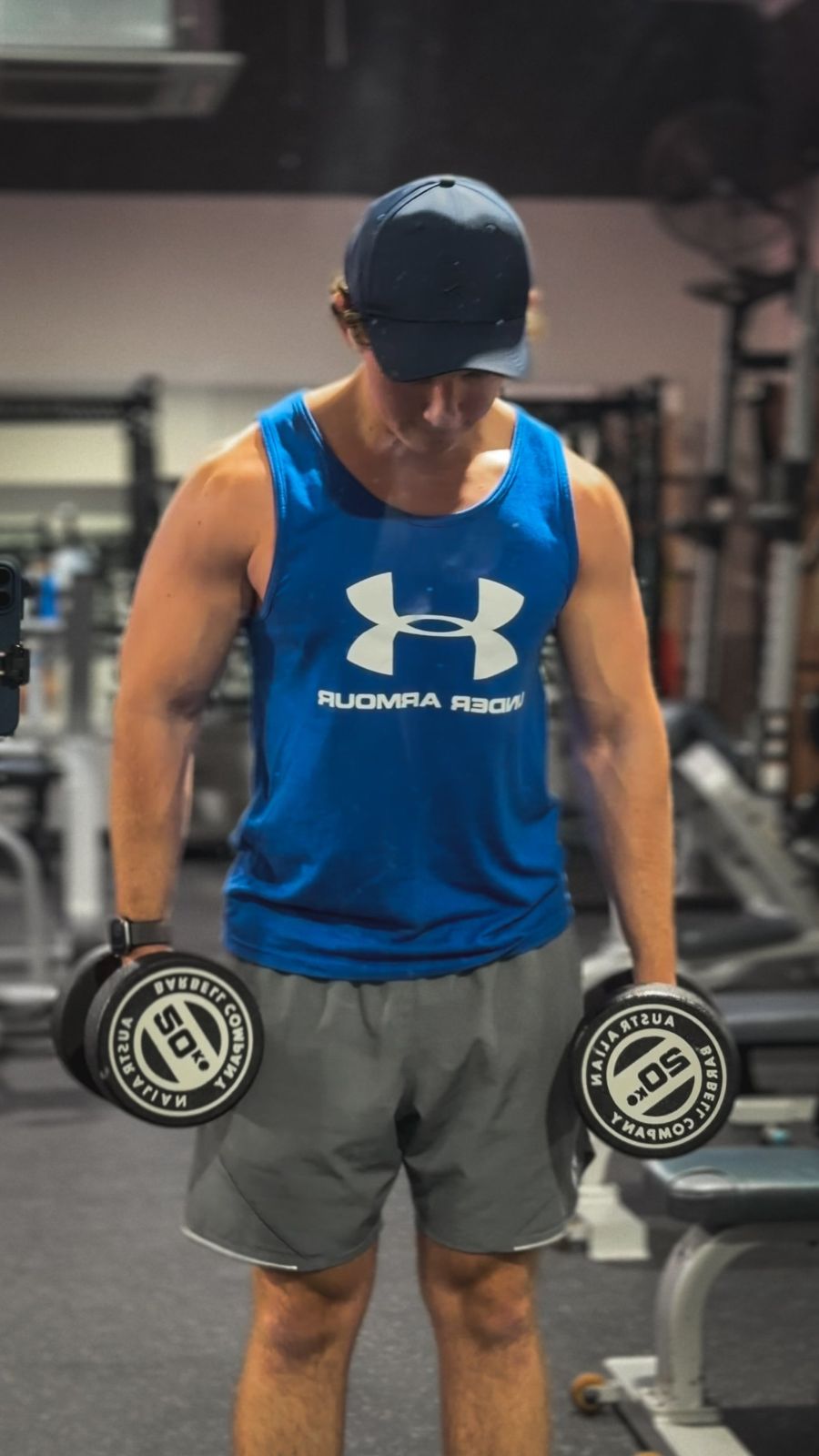Holding a pair of 20 kg dumbbells